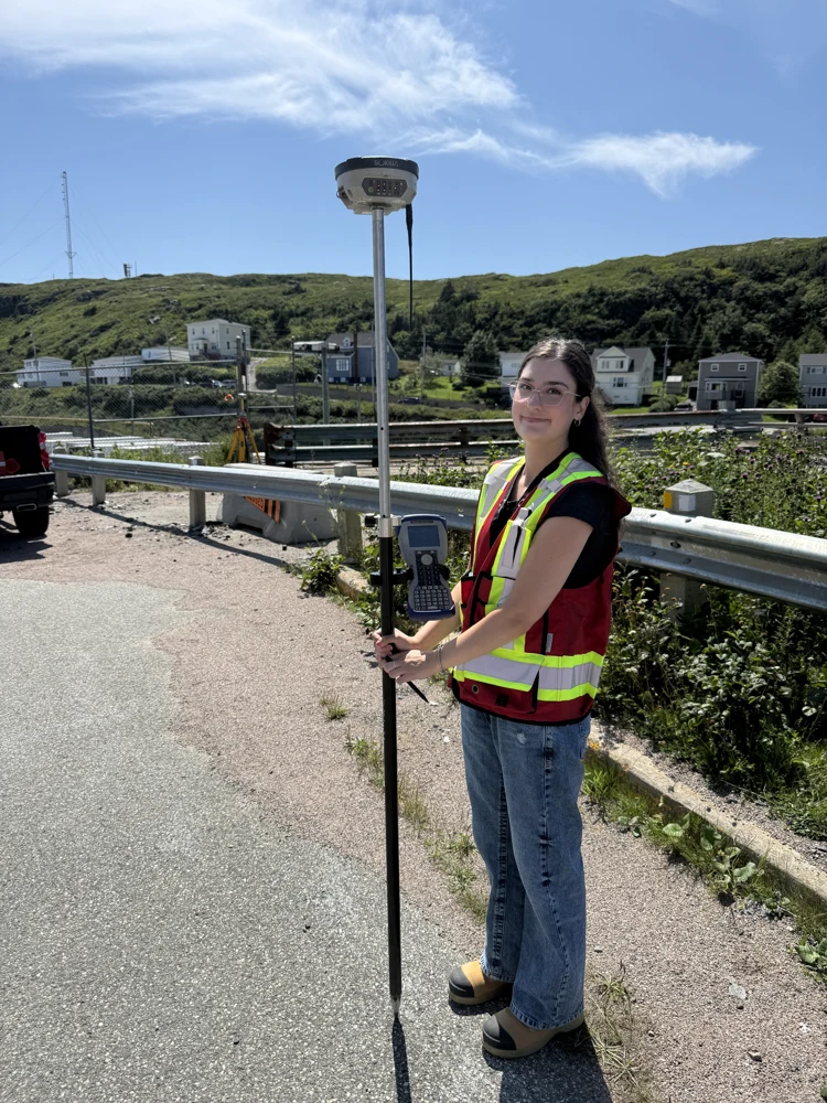Surveyor collecting ground observations with a GNSS survey pole